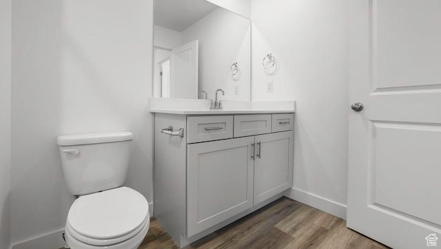1726 S Wolverine Way Unit 174, Washington, UT 84780 - bathroom with baseboards, wood finished floors, toilet, and vanity