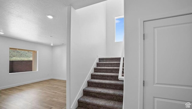 1726 S Wolverine Way Unit 174, Washington, UT 84780 - stairs with a textured ceiling, wood finished floors, recessed lighting, and baseboards