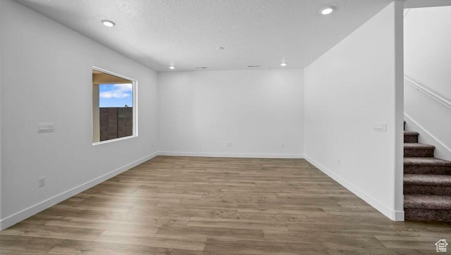 1726 S Wolverine Way Unit 174, Washington, UT 84780 - empty room with recessed lighting, stairway, baseboards, a textured ceiling, and wood finished floors