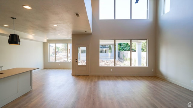 954 W 1880 S, Syracuse, UT 84075 - unfurnished living room featuring recessed lighting, visible vents, light wood-style flooring, and baseboards