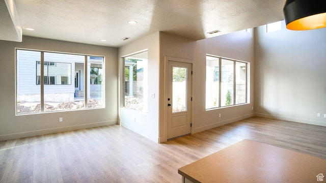 954 W 1880 S, Syracuse, UT 84075 - foyer featuring baseboards, visible vents, a textured ceiling, and light wood finished floors