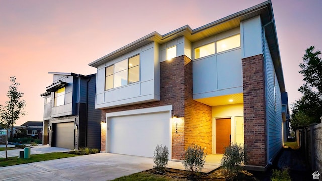 954 W 1880 S, Syracuse, UT 84075 - view of front facade with brick siding, driveway, an attached garage, and stucco siding