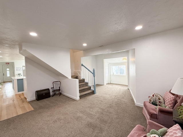 interior space with carpet, recessed lighting, and stairs