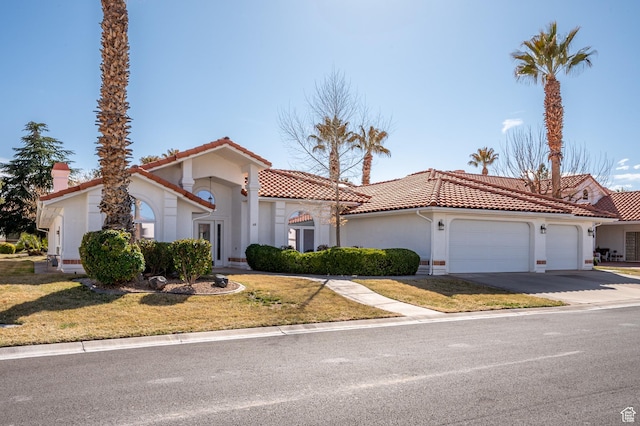 150 S Crystal Lakes Dr Unit 48, St George, UT 84770 - mediterranean / spanish-style house with a garage, a front yard, concrete driveway, and a tile roof