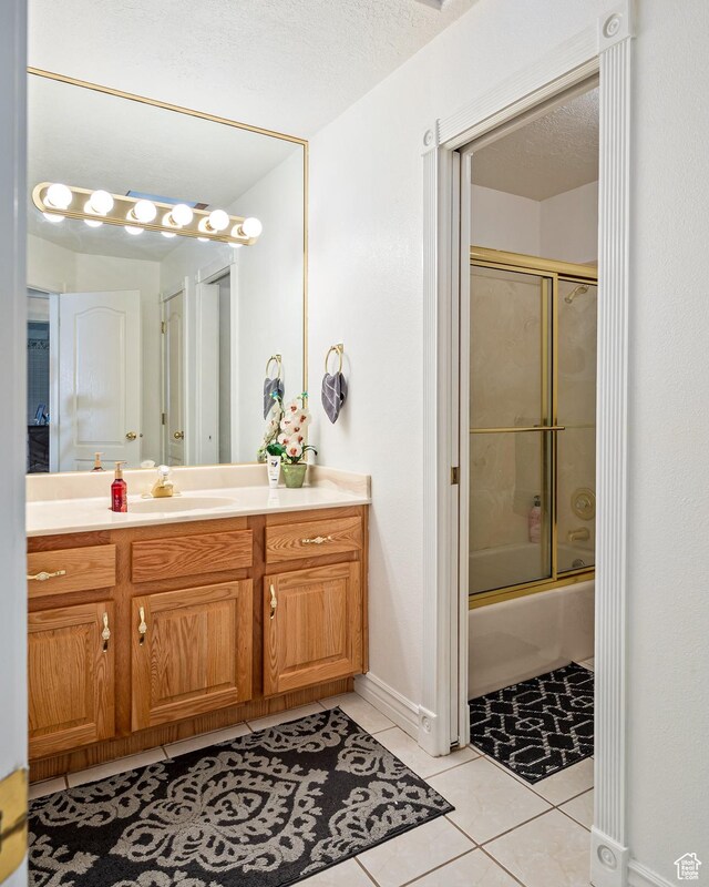 150 S Crystal Lakes Dr Unit 48, St George, UT 84770 - full bath with tile patterned flooring, enclosed tub / shower combo, vanity, and a textured ceiling