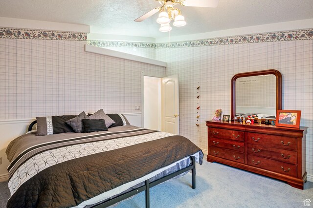 150 S Crystal Lakes Dr Unit 48, St George, UT 84770 - carpeted bedroom featuring a ceiling fan and a textured ceiling