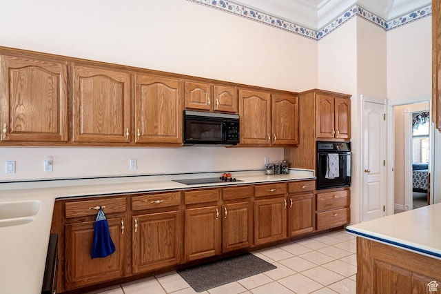 150 S Crystal Lakes Dr Unit 48, St George, UT 84770 - kitchen featuring a towering ceiling, black appliances, brown cabinets, and light countertops