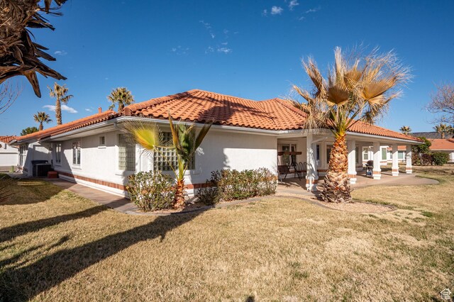 150 S Crystal Lakes Dr Unit 48, St George, UT 84770 - mediterranean / spanish home featuring stucco siding, a tiled roof, a patio area, and a front yard