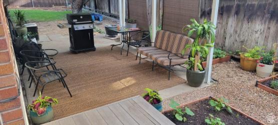 7688 S 1130 E, Midvale, UT 84047 - view of patio / terrace featuring a grill, fence, and a vegetable garden