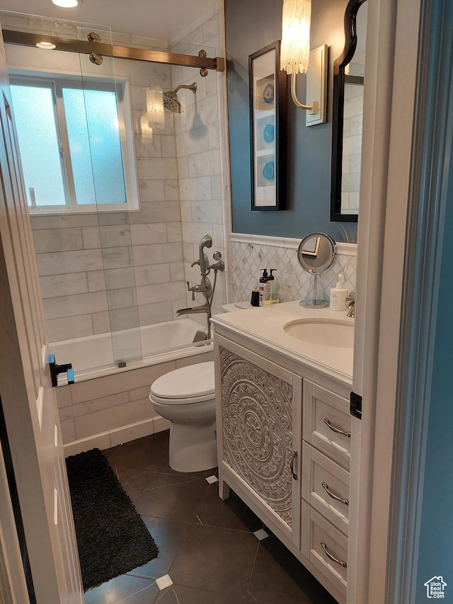 7688 S 1130 E, Midvale, UT 84047 - full bath featuring bath / shower combo with glass door, vanity, toilet, and tile patterned flooring