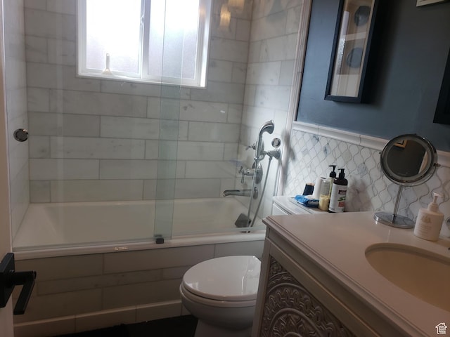 7688 S 1130 E, Midvale, UT 84047 - full bathroom with shower / bath combination with glass door, tile walls, vanity, toilet, and wainscoting