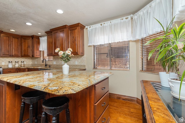 892 S Cambridge Dr, St George, UT 84770 - kitchen with hardwood / wood-style floors, baseboards, a sink, tasteful backsplash, and recessed lighting