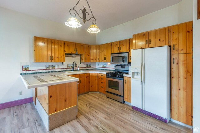 175 W 9200 S, Paradise, UT 84328 - kitchen with a sink, light wood finished floors, tile counters, stainless steel appliances, and backsplash