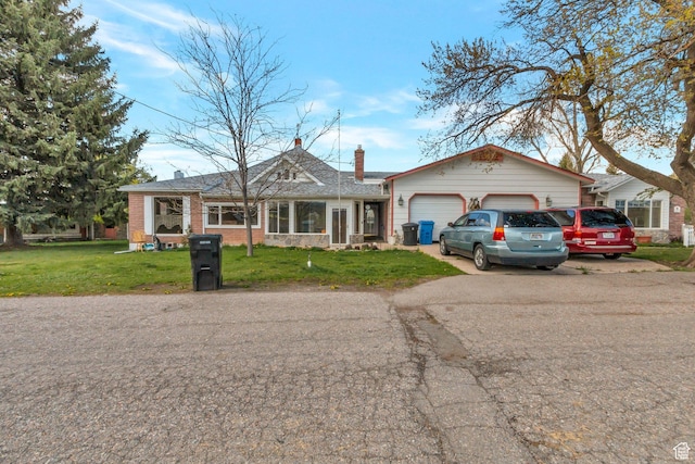 175 W 9200 S, Paradise, UT 84328 - view of front of home featuring a garage, brick siding, a front lawn, and aphalt driveway