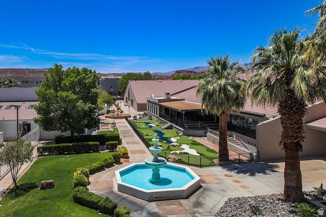 view of swimming pool featuring a yard, fence, and a mountain view