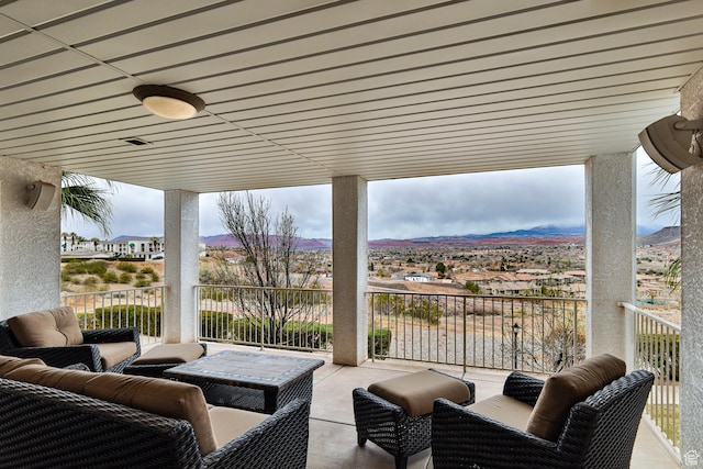view of patio / terrace featuring outdoor lounge area, a mountain view, and a balcony