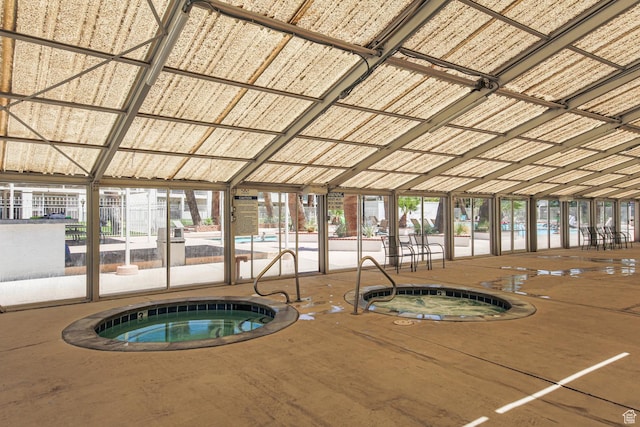 view of swimming pool featuring an indoor hot tub