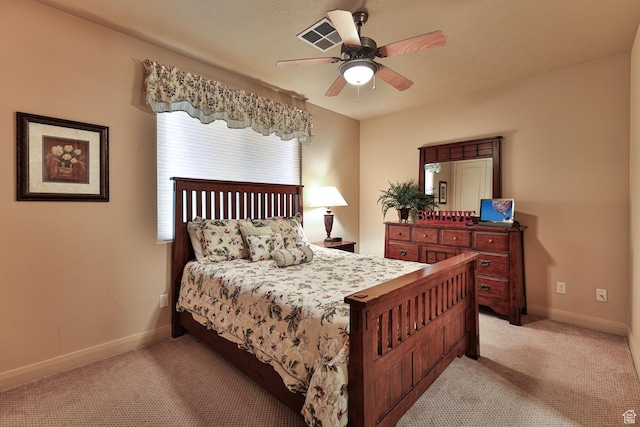 bedroom with a ceiling fan, light colored carpet, and baseboards