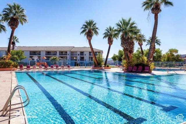 community pool featuring a patio area and fence