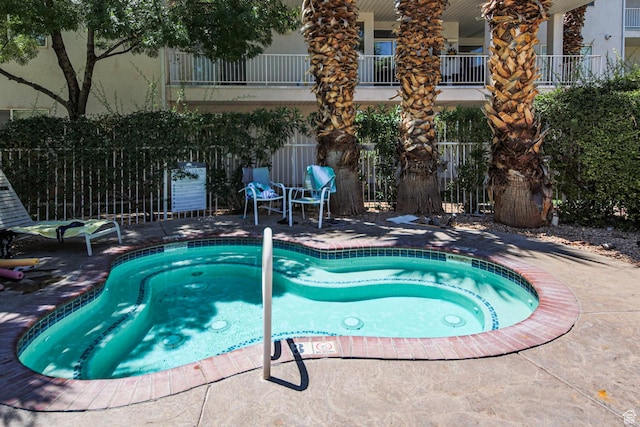 view of pool featuring a patio area and fence