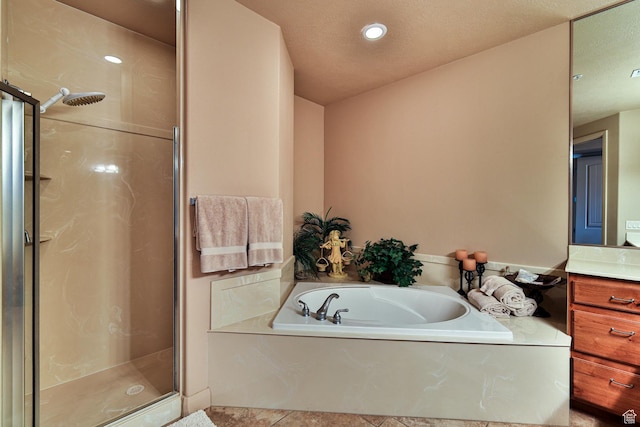 full bathroom with tile patterned floors, a garden tub, vanity, a shower stall, and recessed lighting
