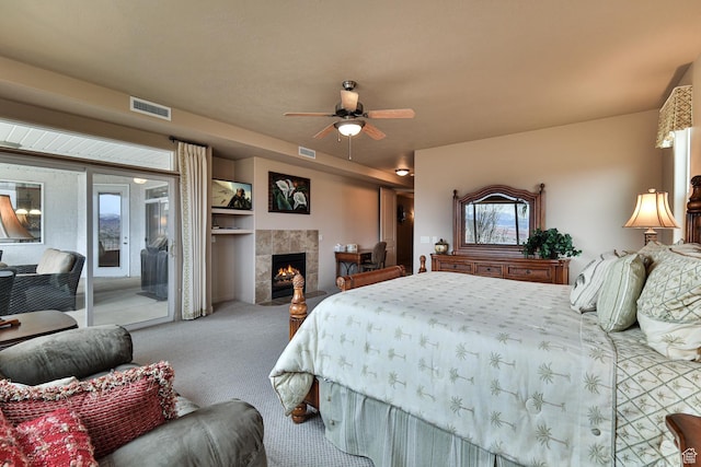 bedroom featuring carpet floors, access to outside, a fireplace, and visible vents