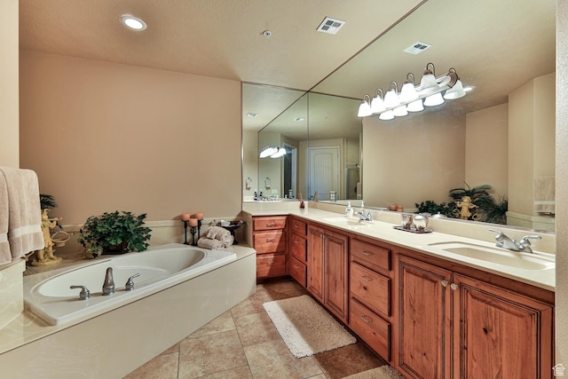 full bath with double vanity, visible vents, a sink, and a bath