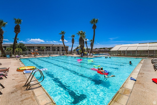 community pool featuring a patio area and fence