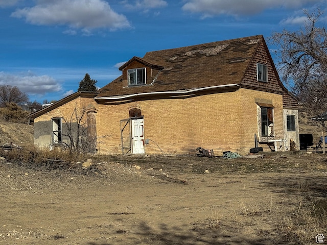 view of property exterior with brick siding