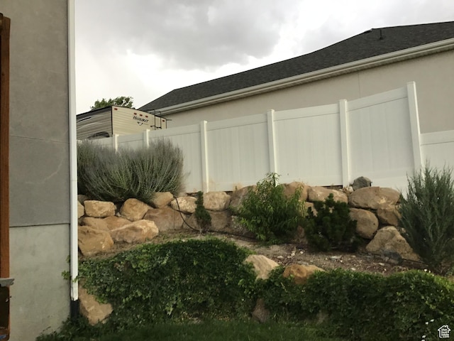 view of side of property featuring fence
