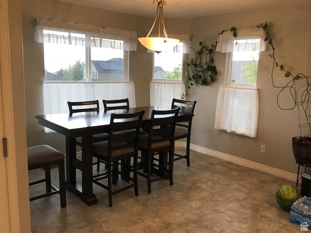 dining space with plenty of natural light and baseboards