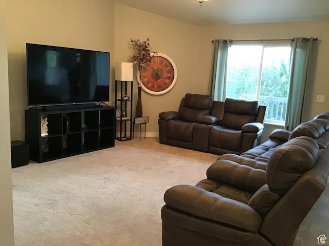 living area featuring carpet flooring and baseboards