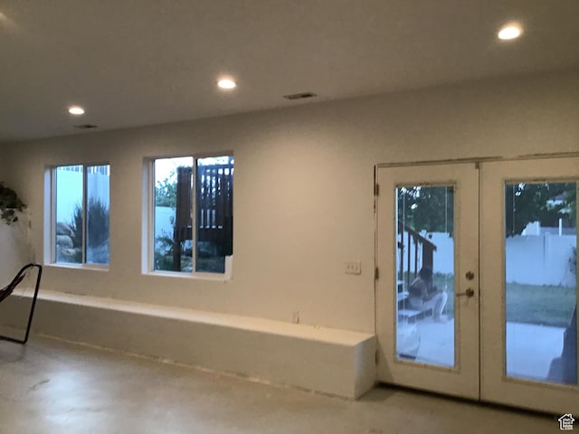 entryway featuring concrete flooring, french doors, visible vents, and recessed lighting