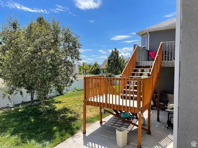 view of yard featuring stairs, a patio, a deck, and fence