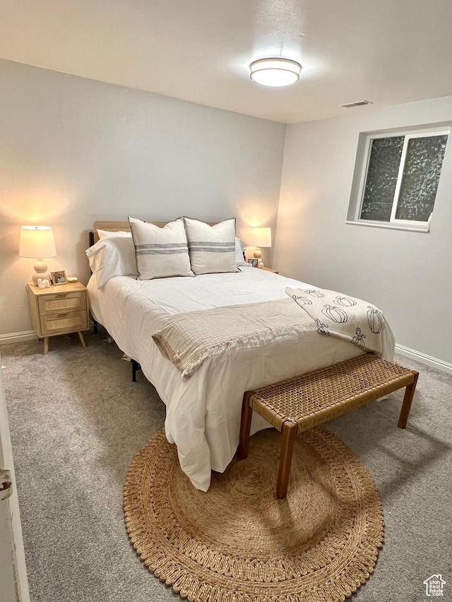 carpeted bedroom featuring visible vents and baseboards