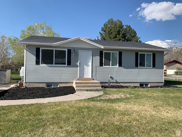 view of front of property with a front yard and cooling unit