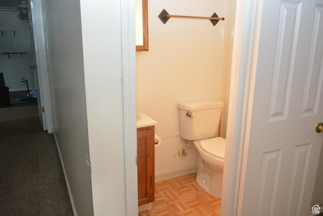 half bathroom featuring toilet and vanity