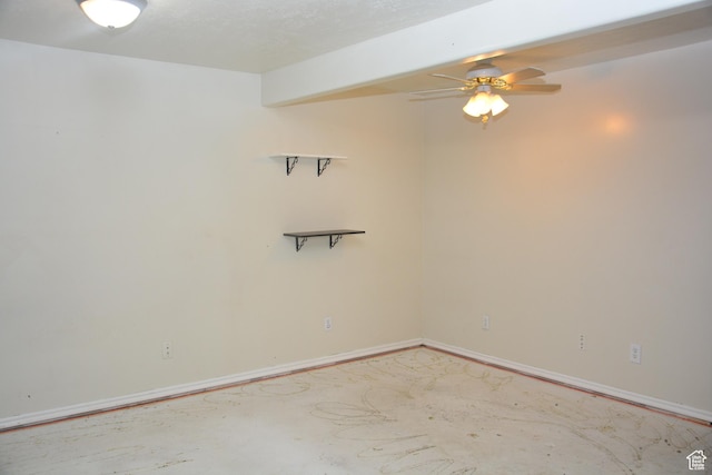 unfurnished room featuring unfinished concrete flooring, a ceiling fan, and baseboards