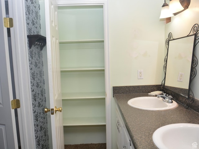 bathroom featuring double vanity and a sink