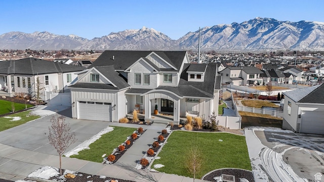 traditional-style home featuring a mountain view, concrete driveway, and a residential view