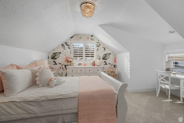 carpeted bedroom with multiple windows, a textured ceiling, baseboards, and lofted ceiling