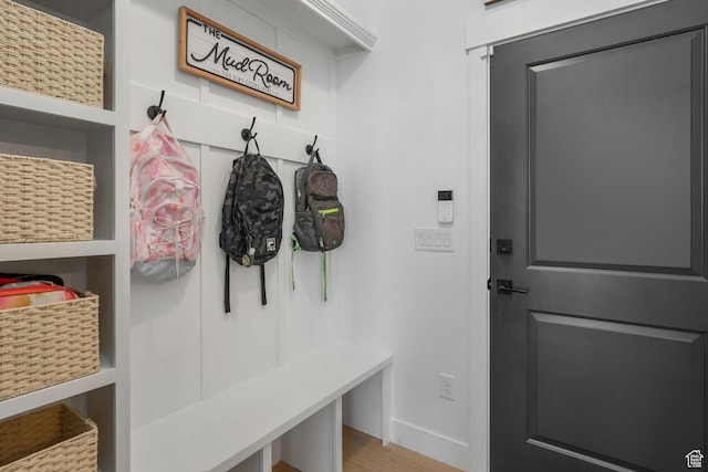 mudroom with baseboards and wood finished floors