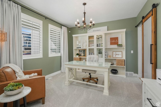 carpeted office space with a barn door, visible vents, baseboards, and an inviting chandelier