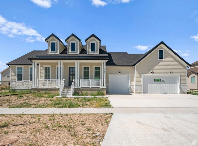 2387 E Canyon Crest Dr Unit 44, Spanish Fork, UT 84660 - view of front of house with a porch, concrete driveway, an attached garage, and roof with shingles