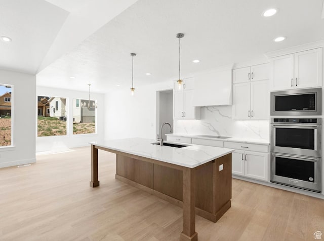 2387 E Canyon Crest Dr Unit 44, Spanish Fork, UT 84660 - kitchen with appliances with stainless steel finishes, light wood finished floors, recessed lighting, backsplash, and light stone counters