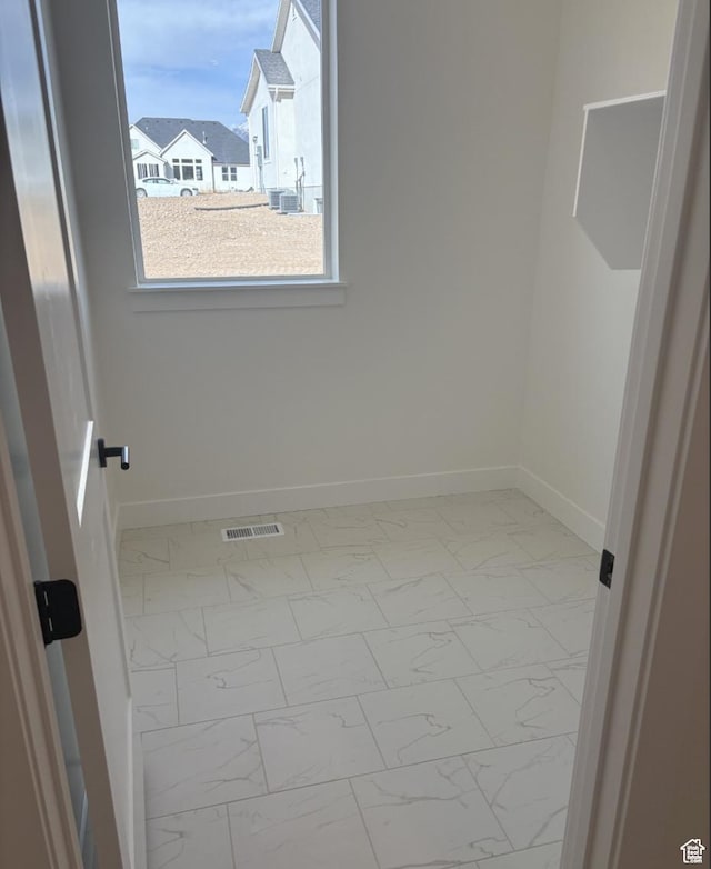 2387 E Canyon Crest Dr Unit 44, Spanish Fork, UT 84660 - spare room with marble finish floor, visible vents, and baseboards