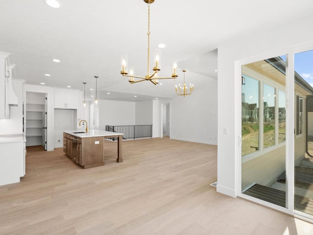 2387 E Canyon Crest Dr Unit 44, Spanish Fork, UT 84660 - kitchen featuring a chandelier, recessed lighting, light countertops, light wood finished floors, and white cabinetry