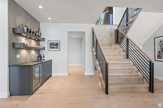 2344 Nighthawk Cir, Park City, UT 84098 - bar with indoor wet bar, light wood finished floors, a sink, beverage cooler, and stairs