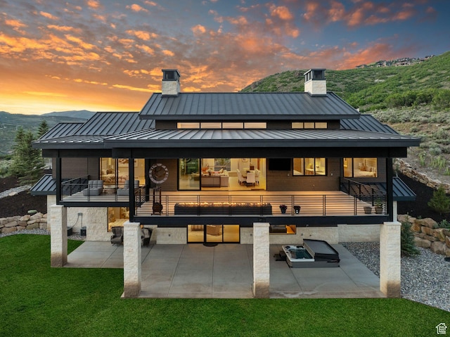 2344 Nighthawk Cir, Park City, UT 84098 - rear view of house with a patio area, metal roof, a standing seam roof, and a chimney