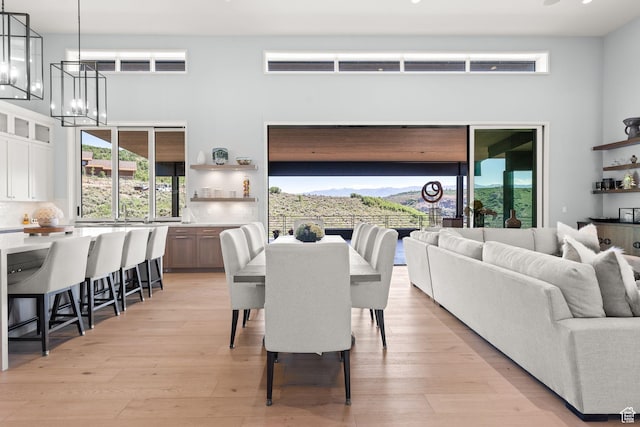 2344 Nighthawk Cir, Park City, UT 84098 - dining space featuring light wood-style flooring, a towering ceiling, and an inviting chandelier